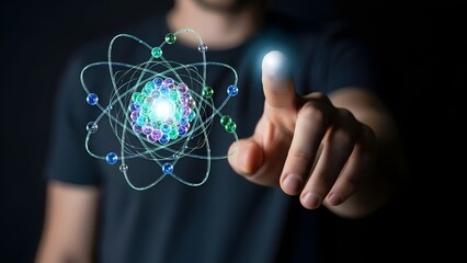 Abstract 3D atom model with glowing nucleus, science and technology concept, man's hand pointing at it