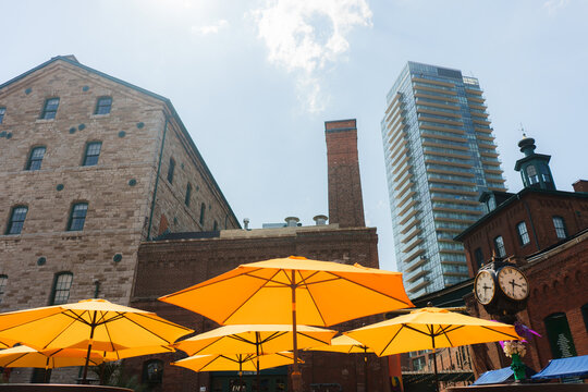 Yellow umbrellas on sunny day in Distillery district in Toronto 