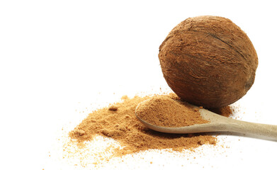 Coconut palm sugar pile in wooden spoon with fruit shell, isolated on white background, side view