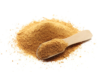 Coconut palm sugar pile with wooden spoon isolated on white background, side view