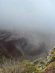 Foggy close-up view of the volcanic crater at the summit of Mount Bisoke in Rwanda.
