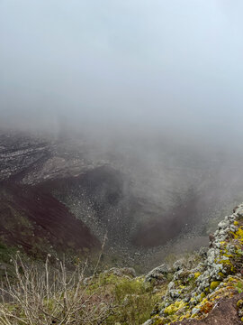 Foggy close-up view of the volcanic crater at the summit of Mount Bisoke in Rwanda.