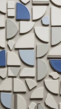 Abstract composition of white and blue ceramic tiles on neutral surface