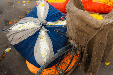 Huge sacks of flowers in carriage on floral market in India 
