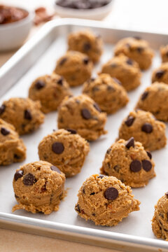 Chocolate chip cookie dough scooped on a baking sheet ready to be baked or frozen