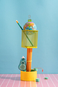 Globe with School Supplies on Colorful Surface