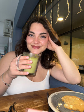 Woman Drinking Matcha Latte

