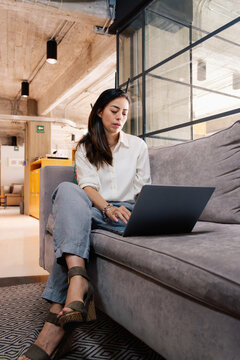 Confident business woman in modern living room.