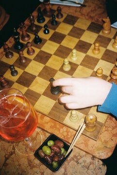 Hand Moving Chess Piece During Game
