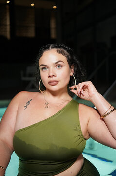Woman in Green One-Shoulder Swimsuit at Night Jacuzzi