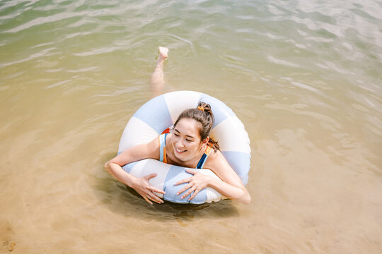Relaxing on the beach with a colorful inflatable ring