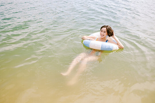 Relaxing on the beach with a colorful inflatable ring