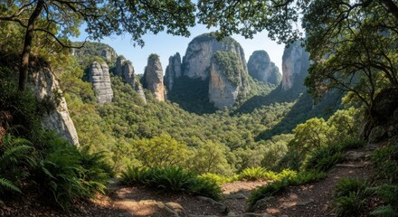 A lush mountain valley framed by trees, revealing rock formations under a bright sky