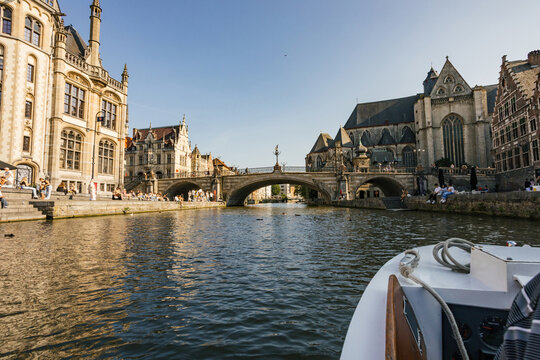 River View of Historic Buildings and Bridge in Ghent at Sunset
