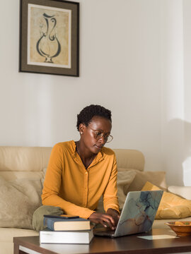 Pensive woman working on laptop