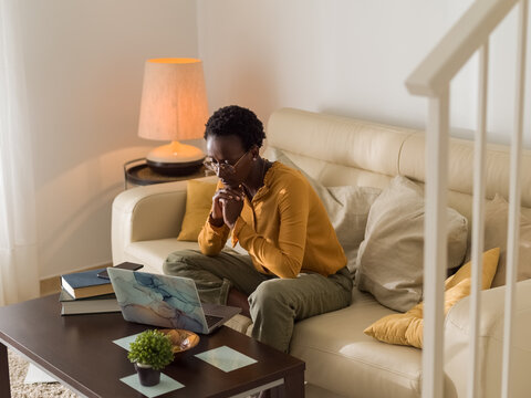 Woman thinking deep while working at home