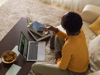 Woman drinking wine at home