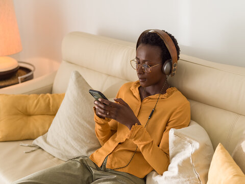 Woman in headphones using smartphone