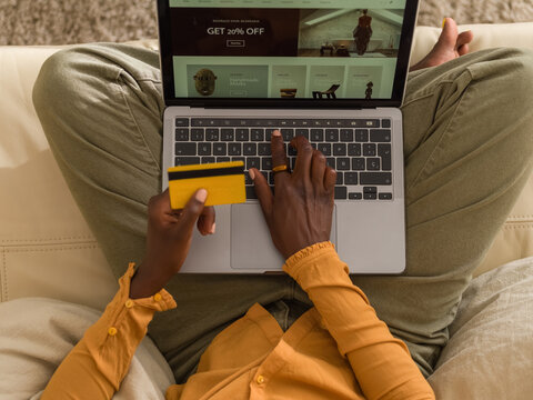 Woman shopping online using laptop and credit card