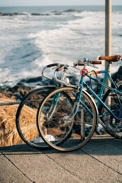 Bicycles Parked Near the Ocean at Sunset in a Coastal Town