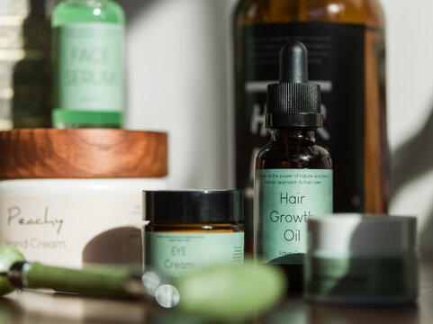 Beauty Products Arranged on a Wooden Surface in Natural Light