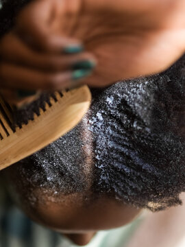 Woman disentangling kinky hair 