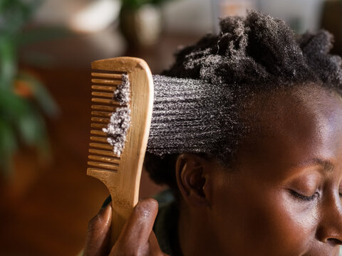 Natural Hair Care Process With Wooden Comb Indoors