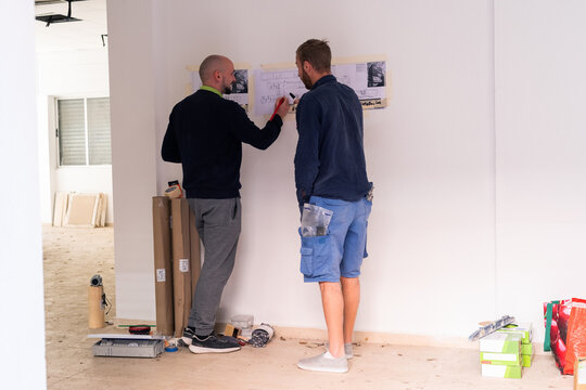 Workmen discussing renovation project