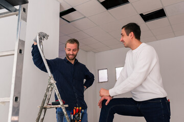 Smiling workers talking at construction site