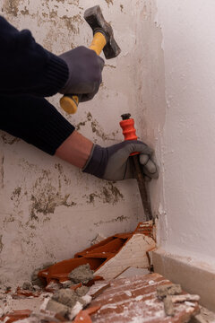 Worker demolishing old wall