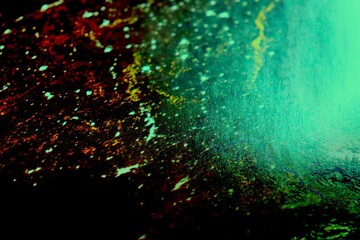 Illustration of an abstract background with colorful lights and explosion. Abstraction and dark background in black, green and red. Pattern and design for textile or fabric. Paper and seamless