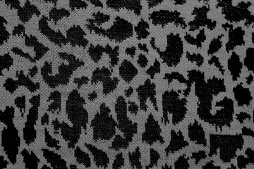  Knitted wool pattern with a leopard design. Fabric and textile with leopard pattern and in grey and black. Textured background for paper or different kind of pattern.