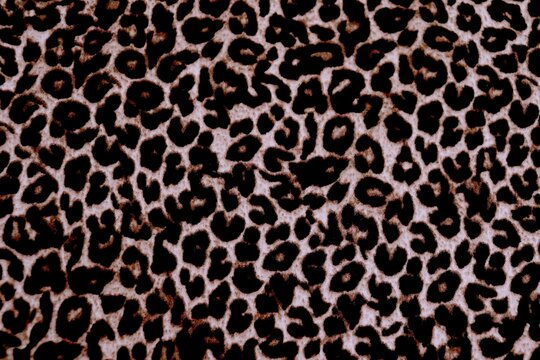  Knitted wool pattern with a leopard design. Fabric and textile with leopard pattern and in brown and black. Textured background for paper or different kind of pattern.