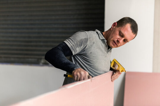 Contractor working with gypsum board