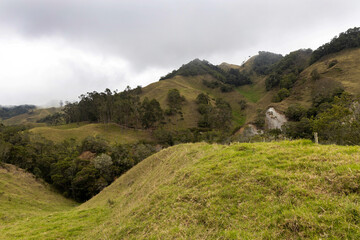 Fields and mountains of the Caldas department under a dramatic sky, representing the natural and rural wealth of Colombia.