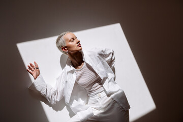 Model posing creatively in a minimalist studio