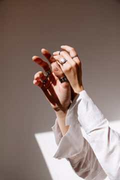 Elegant hands adorned with rings in natural light