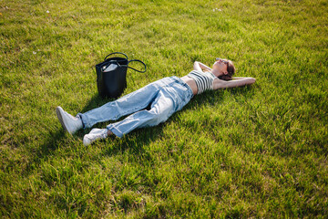 Relaxing on green grass in a park under the sun