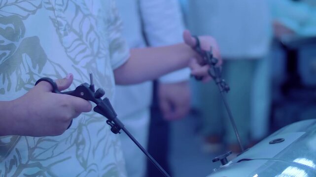 A teenager is learning to become a doctor on a simulator &ndash; laparoscopy is a modern method of minimally invasive surgery through small openings