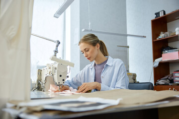 Seamstress refining clothing prototype detail. Creator carefully modifies garment design