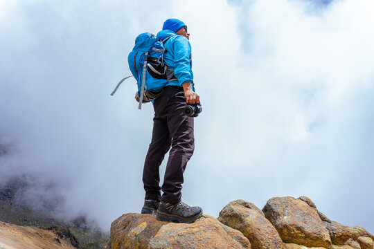 Hiker standing on rocks watching the iztaccihuatl volcano