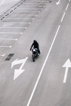 Motorcyclist riding on an empty urban road