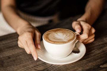 Beautiful woman drinking coffee sitting in a cafe.