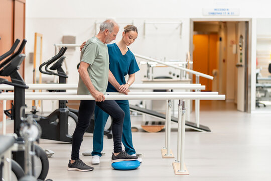 Senior man receiving physical therapy rehabilitation support