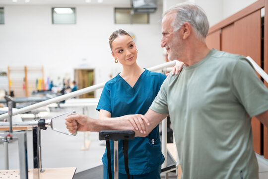 Senior man receiving physical therapy with supportive