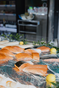 Raw salmon fillets on display at seafood counter