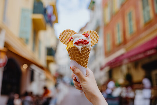 Ice cream cone with wafers held in city street