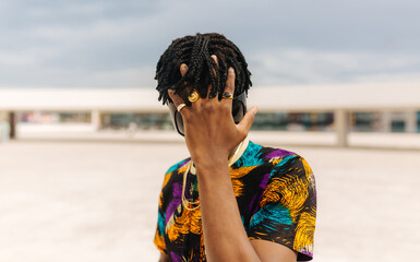 Man covering face with hand