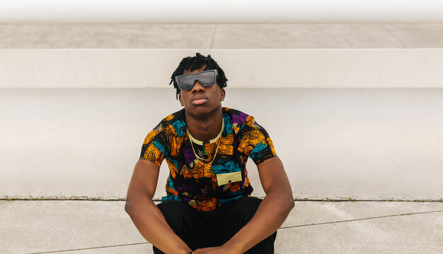 Seated portrait of man in sunglasses