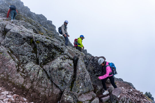 Group hiking rocky terrain on malinche volcano in mexico